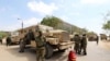 FILE - Burundian African Union Mission in Somalia peacekeepers stand next to an armored vehicle as they prepare to leave the Jaale Siad Military Academy after being replaced by the Somali military in Mogadishu, Somalia, Feb. 28, 2019.