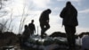 Ukrainian servicemen pile up bags of soil to build a fortification not far from the city of Avdiivka, in Ukraine's Donetsk region, amid Russia's invasion of Ukraine, Feb. 17, 2024.