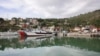 FILE - Vessels are docked at the port of Shengjin, northwestern Albania, Nov. 7, 2023, one of two proposed places to house migrants.