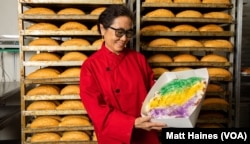 FILE: Huong Tran, owner of Dong Phuong Bakery, shows her popular king cake during Mardi Gras 2021 at the bakery in New Orleans.