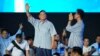Indonesian presidential candidate Prabowo Subianto, left, and his running mate Gibran Rakabuming Raka, the eldest son of Indonesian President Joko Widodo, greet supporters during a gathering in Jakarta, Feb. 14, 2024. 