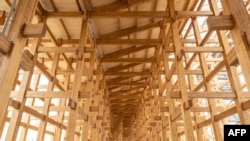 This April 2, 2024, photo shows construction of the 'Grand Roof,' one of the world's largest wooden structures, at the site of the 2025 Expo on Yumeshima island, an area of reclaimed land in Osaka, Japan. 