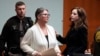 Jennifer Crumbley looks to her attorney Shannon Smith as she is escorted away, Feb. 5, 2024, in Pontiac, Michigan.