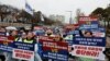 Doctors and Medical workers take part in a protest against a plan to admit more students to medical school, in front of the Presidential Office in Seoul, South Korea, Feb. 21, 2024. 
