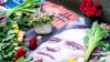 Flowers are placed next to a portrait of Russian opposition leader Alexey Navalny in front of the Russian embassy in Copenhagen, Denmark, Feb. 16, 2024. (Ritzau Scanpix/Ida Marie Odgaard)