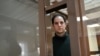 US journalist Evan Gershkovich, arrested on espionage charges, looks out from inside a defendants' cage before a hearing to consider an appeal on his extended pre-trial detention, at the Moscow City Court in Moscow, Feb. 20, 2024. 