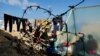 Displaced members of Palestinian Abu Mustafa family, who fled their house due to Israeli strikes, shelter at the border with Egypt, in Rafah in the southern Gaza Strip, Feb. 10, 2024. 