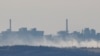 Smoke rises near the Avdiivka Coke and Chemical Plant in the town of Avdiivka during the Russia-Ukraine conflict, as seen from Yasynuvata in the Donetsk region, Russian-controlled Ukraine, Feb.15, 2024. 