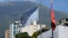 U.N. and Venezuelan flags hang outside the building that houses part of the U.N. human rights office in Caracas, Venezuela, Feb. 15, 2024. Venezuela on Thursday ordered the agency to suspend operations, accusing it of promoting opposition to the country.