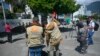 Journalists work in front of the Mexican embassy guarded by police in Quito on Apr. 7, 2024. 