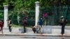 FILE - A man runs after hearing gunshots near the National Palace in Port-au-Prince, Haiti, April 2, 2024. The next day, armed gangs looted Haiti's National Library.