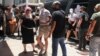 Crew members of a yacht, who allegedly caused a forest fire on the island of Hydra after launching fireworks from the vessel, are transferred to the prosecutor's office at the courthouse of Piraeus, Greece, June 23, 2024. 