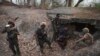 Members of the Karen National Liberation Army and People’s Defense Force interrogate two arrested soldiers after they captured an army outpost, in the southern part of Myawaddy township in Kayin state, Myanmar, March 11, 2024. 
