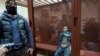 Dalerdzhon Mirzoyev, a suspect in the Crocus City Hall attack, sits in a glass cage at the Basmanny District Court in Moscow, Russia, March 24, 2024. The country's FSB security service said on April 1, 2024, that it arrested four more people it says are linked to the attack.