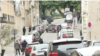 Police set up a cordon around the Iranian consulate in Paris after reports of a person entering the building with an explosive device. (Screenshot from AFP video)