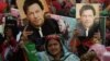Supporters of Pakistan's former prime minister Imran Khan carry placards displaying a portrait of Khan during a protest in Karachi, March 19, 2023, demanding the release of party workers arrested in recent police clashes.
