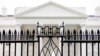 FILE - The White House is visible through the fence at the North Lawn in Washington, on June 16, 2016. A driver died Saturday night, May 4, 2024 after crashing a vehicle into a gate at the White House, authorities said. 
