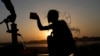 A youth cools off under a hand pump at the sunset during hot weather in Lahore, Pakistan, May 28, 2024. 