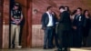 Police and prosecutors stand outside President Dina Boluarte's home during a raid aimed at seizing luxury watches as part of a preliminary investigation into allegations of illicit enrichment, in Lima, Peru, March 30, 2024. 
