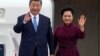 China's President Xi Jinping and his wife Peng Liyuan wave upon their arrival for an official two-day state visit at Orly airport, south of Paris on May 5, 2024. 