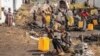 FILE - People displaced by fighting between Congolese forces and M23 rebels gather in a camp on the outskirts of Goma, Democratic Republic of the Congo, March 13, 2024.