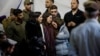 Mourners react during the funeral of Israeli military commander Lieutenant Colonel Tomer Grinberg, who was killed in northern Gaza, at Mount Herzl military cemetery in Jerusalem, Dec. 13, 2023. 