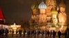 FILE - Police and the Rosguardia (National Guard) servicemen walk in Red Square, closed for celebrations on New Year's Eve, with the St. Basil's Cathedral, in Moscow, Dec. 31, 2022. 