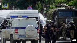 Russian policemen and members of "Rosgvardiya," a Russian national guard, gather not far from a pretrial detention center in Rostov-on-Don, June 16, 2024. 