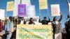 People hold banners in support of LGBTQ rights outside the high court which made a landmark ruling in favour of LGBTQ communities in Windhoek, Namibia, June 21, 2024.