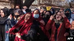 FILE - Afghan women chant slogans to protest against the ban on university education for women, in Kabul on Dec. 22, 2022.