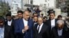 Iranian Foreign Minister Hossein Amir-Abdollahian, center left, walks with his Syrian counterpart Faisal Mekdad, center right, and Iran's Ambassador to Syria Hossein Akbari, center, during a visit to the site destroyed by airstrikes, in Damascus on April 8, 2024. 
