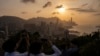 Visitors look at sunset from a hill in Hong Kong, March 22, 2024. 