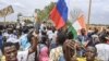 FILE - Supporters of Niger's coup leaders hold a Russian flag as they demonstrate in Niamey on Aug. 11, 2023. Nigerien state media reported on April 11, 2024, that Russian military trainers had arrived in the country.