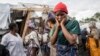 People gather at the side of an explosion in a refugee camp on the outskirts of Goma, Democratic Republic of the Congo, May, 3, 2024. 
