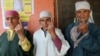 Kashmiri women display the indelible ink mark on their fingers after casting their votes, outside a polling station in Sheeri, about 60 kilometers (37 miles) north of Srinagar, India, May 7, 2014.