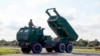 FILE - A High-Mobility Artillery Rocket System (HIMARS) in operation during military exercises at Spilve Airport in Riga, Latvia, Sept. 26, 2022. 