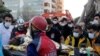 Rescue workers carry a 7-year-old girl rescued from a collapsed building in Izmir, Turkey, Oct. 31, 2020.