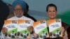 India&#39;s Prime Minister Manmohan Singh (L) and Chief of India&#39;s ruling Congress party Sonia Gandhi hold their party&#39;s manifesto for the April/May general election in New Delhi, March 26, 2014.