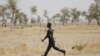 FILE - A civilian vigilante carries a bow and arrow while patrolling with the Cameroonian military in Kerawa, Cameroon, March 16, 2016.