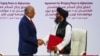 Mullah Abdul Ghani Baradar, leader of the Taliban delegation, and Zalmay Khalilzad, U.S. envoy for peace in Afghanistan, shake hands after signing an agreement in Doha, Qatar, Feb. 29, 2020.