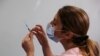 FILE - A medical worker prepares to administer a second vaccination injection against the coronavirus disease as Israel continues its national vaccination drive, during a third national COVID-19 lockdown, at Tel Aviv Sourasky Medical Center, Jan. 10, 2021