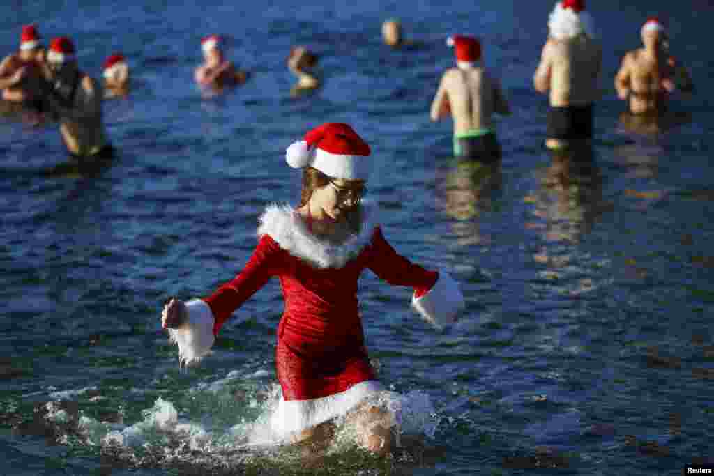 Members of the ice swimming club &quot;Berliner Seehunde&quot; (Berlin Seals) take a dip in the Orankesee lake as part of their traditional Christmas swimming session in Berlin, Germany.