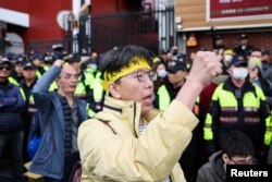 People protest outside parliament while Taiwanese lawmakers vote on the third reading of amendments to the Civil Servants Election and Recall Act and other controversial bills at the Legislative Yuan in Taipei on Dec. 20, 2024.