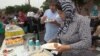 Members of Masjid al-Fatiha, a mosque in Azusa, California, sharing a meal of Middle Eastern and Thai food as they celebrate the Muslim festival of Eid al-Adha, Sept. 12, 2016. (VOA/ M. O'Sullivan) 