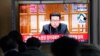 People watch a TV showing a file image of North Korean leader Kim Jong Un shown during a news program at the Seoul Railway Station in Seoul, South Korea, Thursday, Jan. 20, 2022. (AP Photo/Ahn Young-joon)
