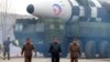 North Korean leader Kim Jong Un walks away from what state media report is a "new type" of intercontinental ballistic missile (ICBM) in this undated photo released on March 24, 2022, by North Korea's Korean Central News Agency (KCNA).
