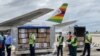 Health officials guard Zimbabwe’s donation of 200,000 Sinopharm COVID-19 vaccine doses, which arrived at the Robert Gabriel Mugabe International Airport in Harare on Feb. 15, 2021. The vaccines were a donation by Beijing. (Columbus Mavhunga/VOA)