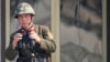 A North Korean soldier watches the South Korean side at the border village of Panmunjom in the demilitarized zone (DMZ) in South Korea, April 4, 2013.