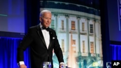 President Joe Biden takes his seat after speaking at the annual White House Correspondents' Association dinner, April 30, 2022, in Washington.