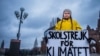FILE - Swedish girl Greta Thunberg, 15, holds a placard reading "School strike for the climate" during a manifestation against climate change outside the Swedish parliament in Stockholm, Sweden, Nov. 30, 2018.